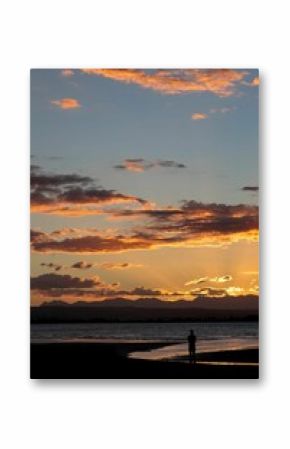 Vertical of a sunset over the beach in Nelson, New Zealand.