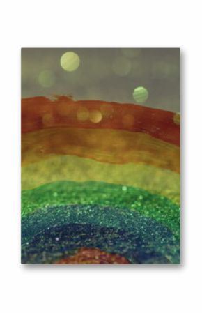 Image of hand painted rainbow over glowing sand falling in background
