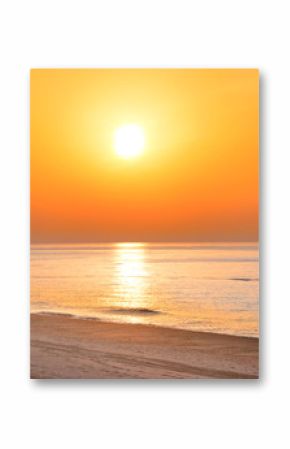 Sunset on the beach with long coastline, sun and dramatic sky 