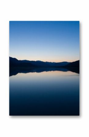 Scenic view of lake against clear blue sky