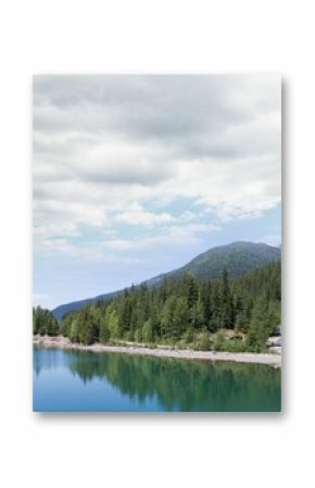 Trees reflecting in calm lake against sky