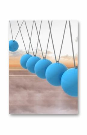 Newtons cradle above beach