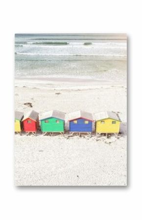 Multi colored wooden huts by mountain at beach