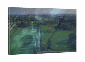 Stretching central tree-lined walkway through urban park, showing lamp posts, benches, pond and HUD