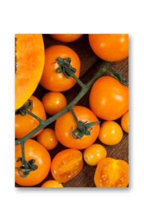 Image of fresh organic vegan food with orange vegetables on wooden board