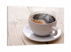 Cup of hot coffee on an old wooden table.