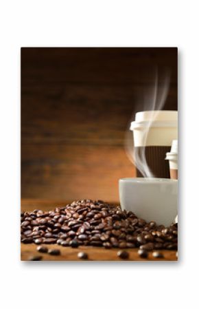Cups of coffee and coffee beans on old wooden background