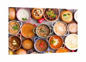 Variety of Garnished Soups in Colorful Bowls