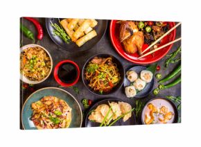 Assorted Chinese food set. Chinese noodles, fried rice, dumplings, peking duck, dim sum, spring rolls. Famous Chinese cuisine dishes on table. Top view. Chinese restaurant concept. Asian style banquet