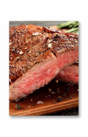 Medium Rare Ribeye steak on wooden board, selected focus