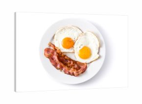 Fried eggs and bacon for breakfast isolated on white background. Top view