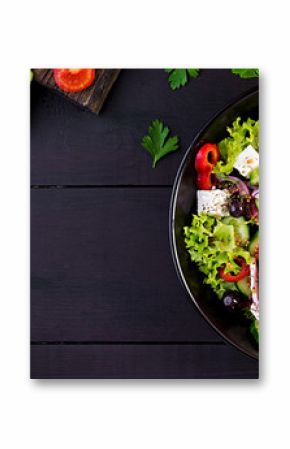 Healthy food. Greek salad with cucumber, tomato, sweet pepper, lettuce, red onion, feta cheese and olives.  Top view, banner