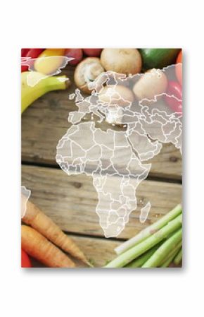 Image of world map over fruits and vegetable lying on table