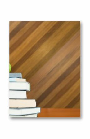 Green apple on pile of books