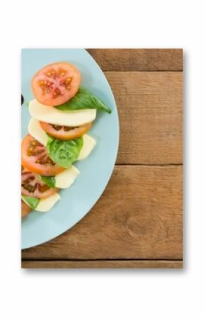 Fresh salad in plate on wooden table