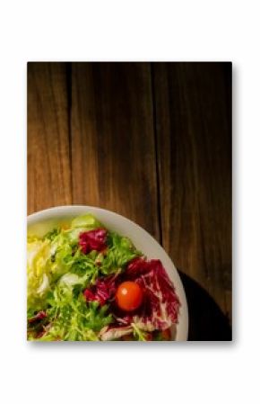 Salad in bowl on wooden table
