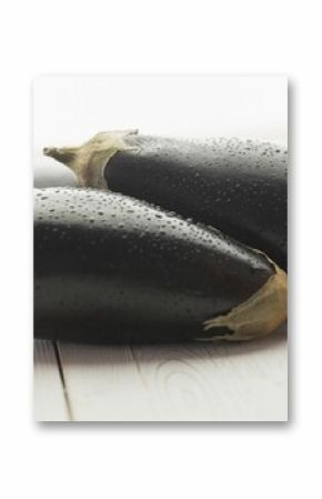 Wet eggplants on hardwood floor