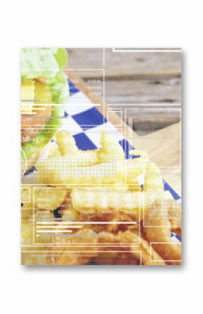 Displaying lettuce-topped burger with fries on checkered wax paper on tabletop, with data overlays