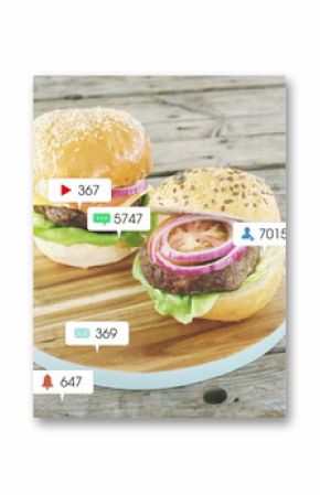 Showing two cheeseburgers resting on wooden board at rustic table, with floating notification icons
