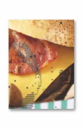 Resting bacon cheeseburger revealing melted cheese and bacon strips at cafe, in green-and-white box