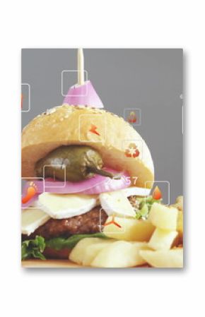 Displaying three mini burgers on wooden board with sweet potato fries in studio, with data icons