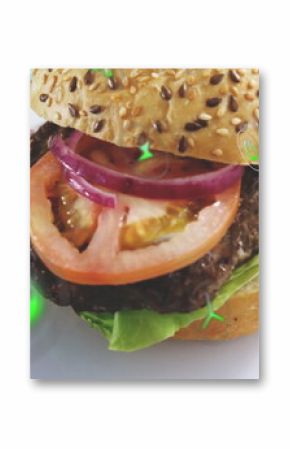 Presenting seeded burger with beef patty, tomato slices and onion rings on plate on turquoise table