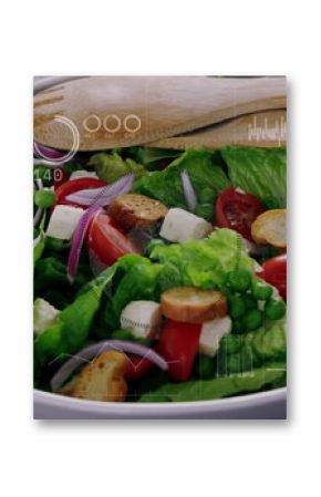 Displaying white ceramic bowl holding fresh salad and wooden spoons on wooden table with overlay