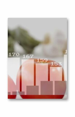 Displaying two red tomatoes shining on white tabletop, with spinach pasta, garlic and chart overlay
