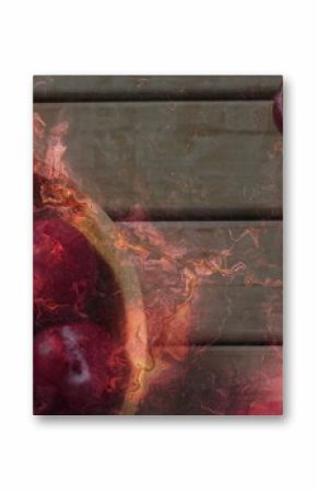 Displaying wooden bowl holding red plums on rustic wooden tabletop, with amber-orange overlay