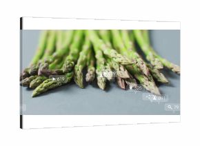 Showcasing green asparagus spears resting on studio countertop, featuring social media icons