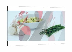 White ceramic bowl holding mushroom fettuccine with chives on table, with graphic overlays