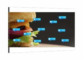 Showcasing cheeseburger with sesame bun and patty on wooden board, notification bubbles, copy space