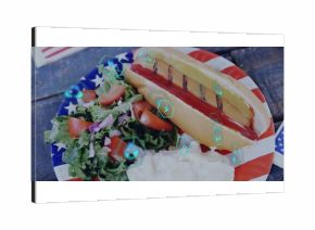 Featuring patriotic plate holding hot dog with sauces, potato salad on wood table, energy icons