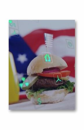 Two mini hamburgers resting on wooden board in studio, with flag backdrop ketchup mustard eco icons
