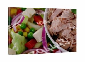 Showing white bowl with flaked tuna at right on table, salad, herb, numeric overlays, copy space