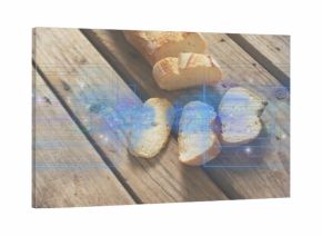 Displaying partially sliced crusty baguette with three slices on picnic table, blue HUD overlay