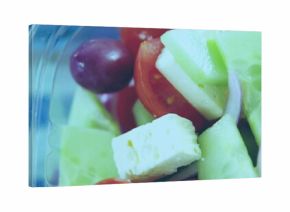 Showing salad at deli with clear plastic clamshell rim cucumber cherry tomatoes grape feta onion