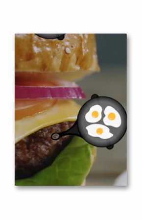 A hamburger with eggs floating around it rests on plate