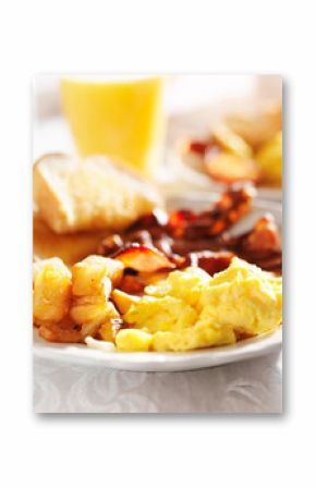 full breakfast with scrambled eggs, fried potatoes and bacon,