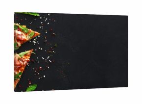 Slices of pizza with spices on black background