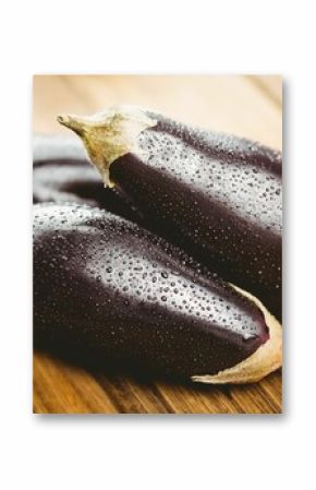 Wet eggplants on wooden floor