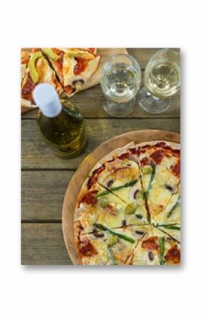 Pizza with white wine served on wooden table