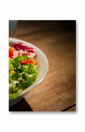 Healthy bowl of salad on wooden table