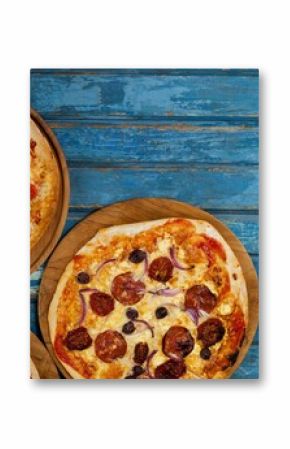 Fresh pizzas on blue wooden table
