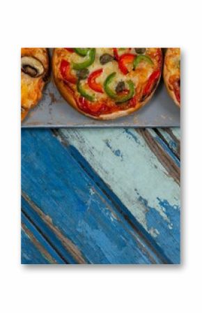 Cropped image of pizzas on weathered table