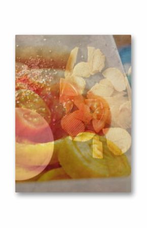 Presenting tray holding tomato halves, chips at deli, with rice crackers, rolls on blue surface