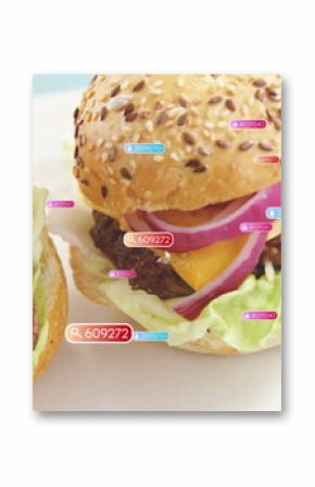 Displaying two cheeseburgers resting on ceramic plate on blue tabletop, with digital numeric tags