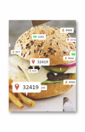 Featuring seeded hamburger with melted cheese and French fries on wooden table, with digital icons