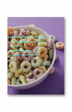 White bowl holding rings, sitting on purple tabletop, with silver spoon and turquoise UI overlay