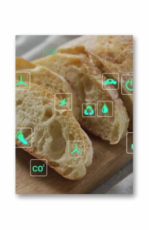 Showing crusty baguette slicing on board over grey linen on kitchen table, with eco overlay icons